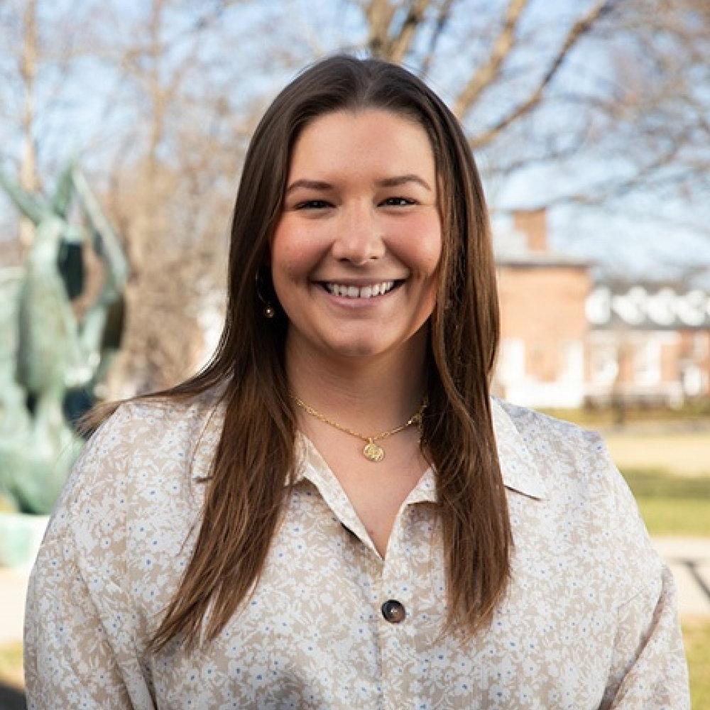 mckenna hulette - woman with brown hair wearing khaki sweater